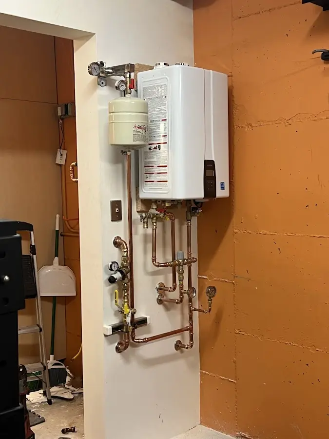 Plumbing technician inspecting water heater connections in Stroudsburg